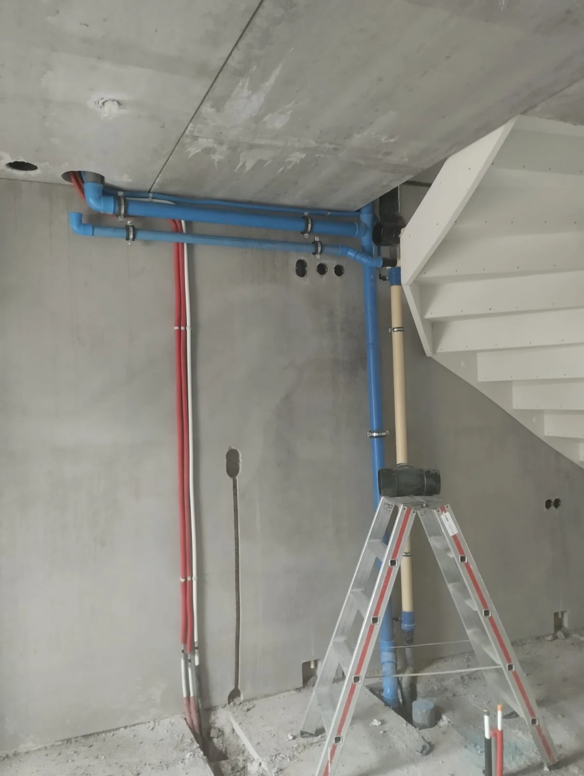 Water supply lines and manifolds in a utility area