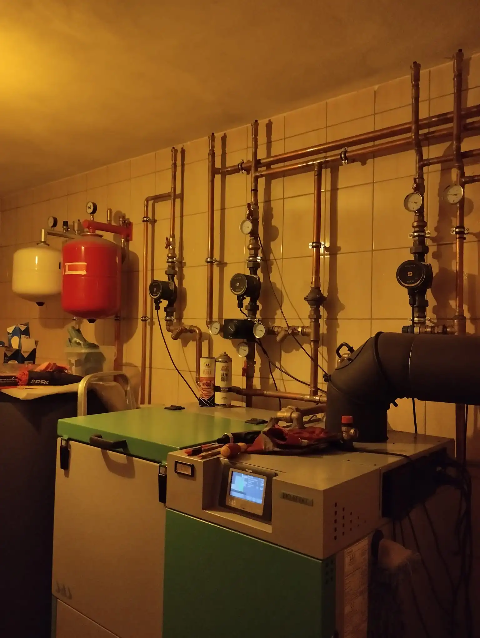 Technician mounting a new boiler in a boiler room